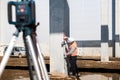 Industrial surveyor on construction site, working with thodolite, gps system and level machine Royalty Free Stock Photo