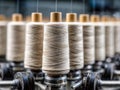 Industrial textile production featuring rows of identical beige thread spools mounted on a spinning machine in a factory setting Royalty Free Stock Photo