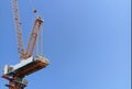 Industrial tower crane is operating at height. High building construction site. Royalty Free Stock Photo