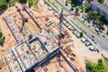 Industrial tower crane standing high at city construction site. aerial view