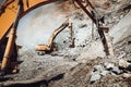 Industrial track type excavator digging at a quarry or a construction site,