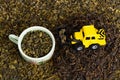 Industrial tractor toy load green tea leafs to cup
