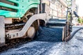 Industrial truck laying fresh bitumen and asphalt