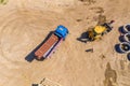 Industrial truck loader excavator moving earth and unloading. Aerial view Royalty Free Stock Photo
