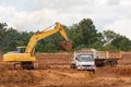 Industrial truck loader excavator moving earth and unloading int Royalty Free Stock Photo