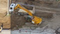 Industrial truck loader excavator moving ground and loading into a dumper truck timelapse Royalty Free Stock Photo