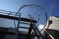 Industrial vertical stairs with clear skybackground.Vertical stair of building.Steel ladder with protection. Royalty Free Stock Photo