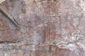 Industrial wall of coarse aggregate with efflorescence, neutral shades, rusted pipe, creative copy space