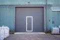 Industrial warehouse with dark grey door for vehicle.