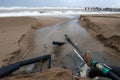 Industrial wastewater, the pipeline discharges liquid industrial waste into the sea on a city beach. Dirty sewage flows from a