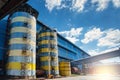 Industrial water tanks. Outdoor steel bulk storage tanks with blue sky view