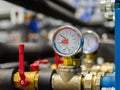 Industrial water temperature and pressure meter on pipe Royalty Free Stock Photo