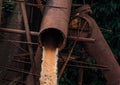 Industrial water waste with rusted old pipes