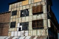 Industrial weathered urban building with rusting window grill and discoloured painted wall surface