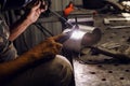 Industrial welder worker welding using argon machine, close up. Male in face mask welds with argon welding. Royalty Free Stock Photo