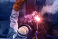 Industrial welding, Worker with protective mask welding bore pile metal casing at a construction site