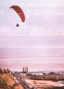 The industrial west cliff side of Ramsgate royal harbour, Kent, UK as a paraglider flies overhead