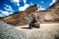 Industrial wheel loader working on construction site. Industrial machinery loading and transporting gravel