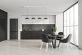 Industrial white and black kitchen with dining area