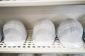 Industrial white safety helmet storage in factory