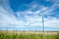 Industrial wind turbines in middle of the fields. Renewable energy source. Ecological energy concept. Eco power. Summer sunny Royalty Free Stock Photo