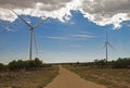 Industrial windmills create a wind farm in the landscape. Royalty Free Stock Photo