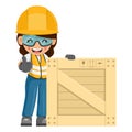 Industrial woman worker with thumb up with wooden box on pallet for delivery, storage and shipping. Industrial safety and