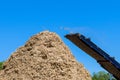 An industrial wood chipper at work roots grinding machine to become chip Royalty Free Stock Photo