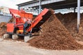 Industrial woodchipper producing wood chips Royalty Free Stock Photo