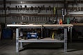 an industrial workbench with tools and supplies in the background