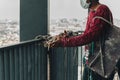 Industrial worker adjusting climbing gear preparing safety rope. Royalty Free Stock Photo