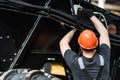 Industrial worker assembles agricultural equipment