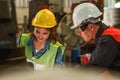 Industrial worker background of industrial chief engineer explaining job detail to factory worker in metal work manufacturing