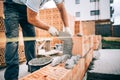 industrial worker, bricklayer installing bricks on construction site Royalty Free Stock Photo