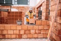 Industrial worker, bricklayer, mason working with bricks
