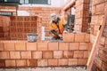 Industrial worker, bricklayer, mason working with bricks