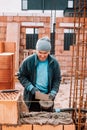 Industrial worker, bricklayer and mason working with bricks and building interior Royalty Free Stock Photo