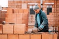 industrial worker, bricklayer and mason working with bricks Royalty Free Stock Photo