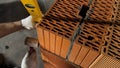 Industrial worker building exterior walls, using hammer and level for laying bricks in cement. Stock footage. Detail of Royalty Free Stock Photo