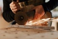 Industrial worker cutting metal with many sharp sparks. Selection focus to cutting machine. Copyspace