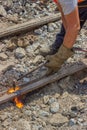 Industrial worker cutting a old tram tracks with an oxy-acetylene torch