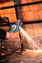 Industrial worker cutting steel with angle grinder Royalty Free Stock Photo