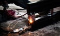 Industrial Worker at the factory welding closeup. Electric wheel grinding on steel structure in factory. Royalty Free Stock Photo