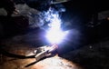 Industrial Worker at the factory welding closeup. Electric wheel grinding on steel structure in factory. Royalty Free Stock Photo