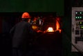 Industrial Worker at the factory welding closeup. Hot iron in smeltery held by a worker