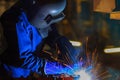 Industrial worker is welding in construction plant