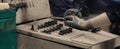 Industrial worker in gloves operating machine on control panel in metal industry plant Royalty Free Stock Photo