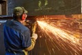 Worker grinding weld seam with grinder machine and sparks Royalty Free Stock Photo