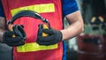 Industrial worker holding ear protection gear equipment. Royalty Free Stock Photo