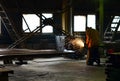 Industrial Worker labourer at the factory welding steel structure